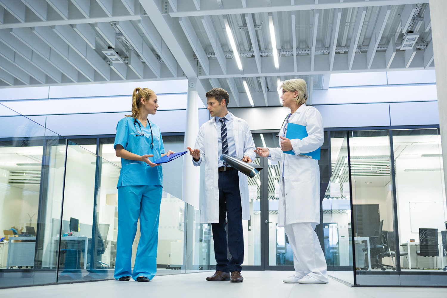 Healthcare professionals discussing patient charts in a hospital, representing the medical sector's role as one of the largest employers in Utah